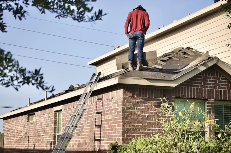Professional roofer working on a residential roof in Bryar